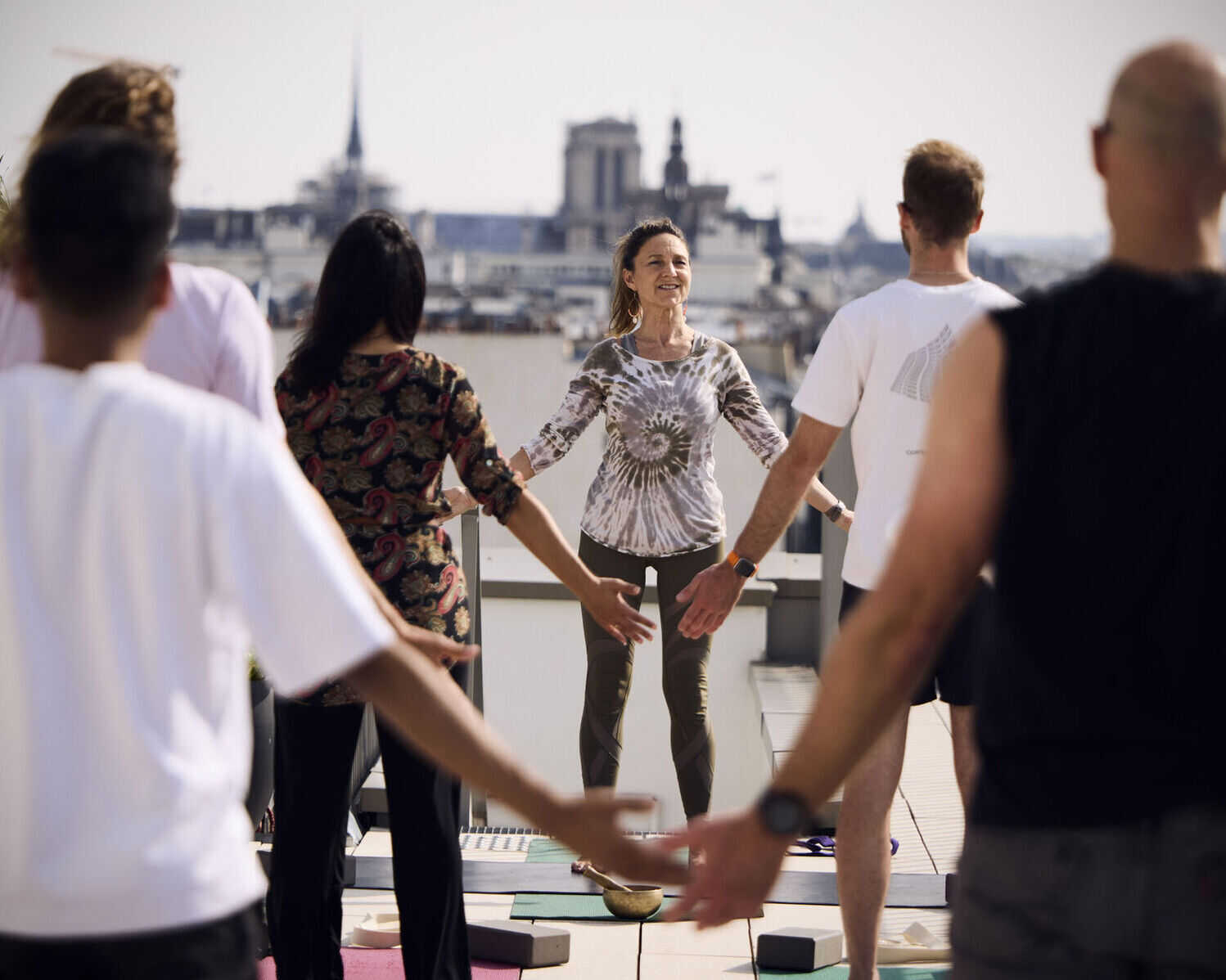 Bridget Jennings Dumont leads a rooftop exercise session.