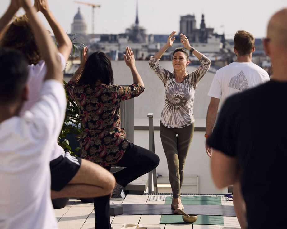 Bridget Jennings Dumont leads a rooftop yoga session.