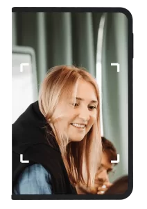 Photo of woman smiling framed by a Ledger signer device